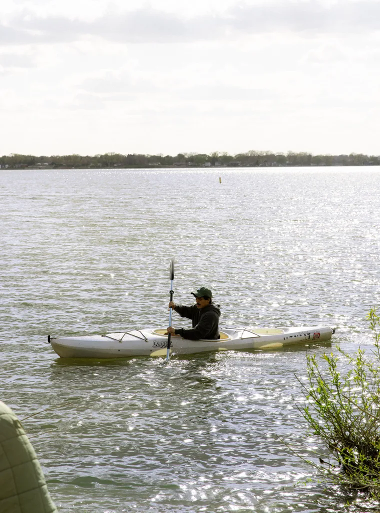 Student kayaking on the lake
