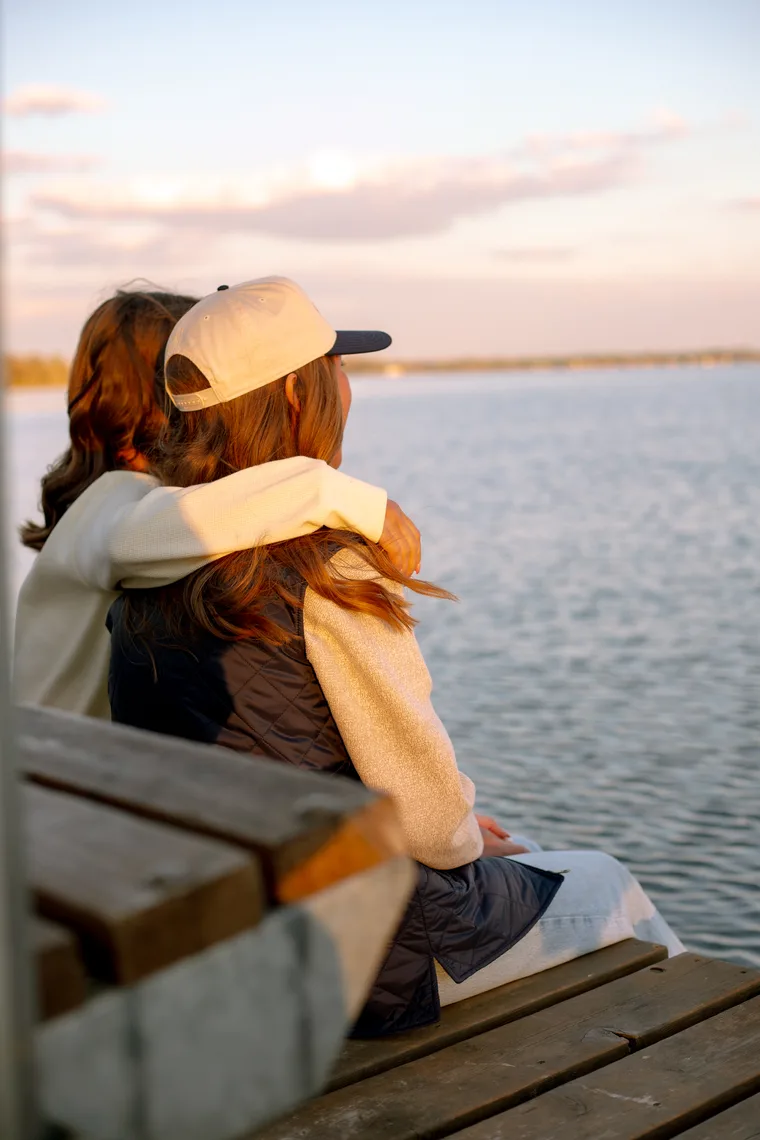 Students hugging on dock